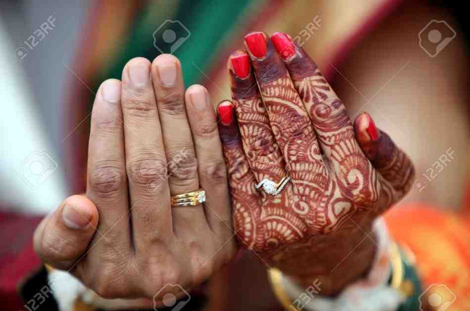 Indian bride and groom exchanging wedding rings