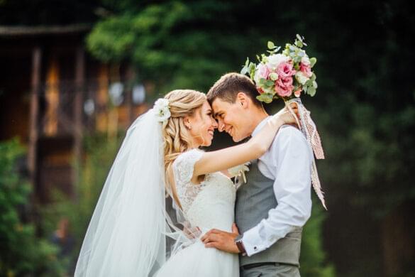 a man and woman in wedding attire hugging